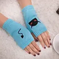 Detail showing embroidered devil face and tail on blue knitted fingerless gloves - Devil Pattern Fingerless Gloves (ST19 Devil Tail) / Light Blue