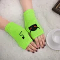 Detail of neon green knitted fingerless gloves with black devil embroidery. - Devil Pattern Fingerless Gloves (ST19 Devil Tail) / Neon Yellow