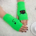 Close-up detail of neon green knit fingerless gloves with black devil embroidery. - Devil Pattern Fingerless Gloves (ST19 Devil Tail) / Fluorescent Green