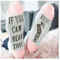 Close-up view of funny cotton crew socks with 'Bring Me Chocolate' text on soles - One Size / Pink