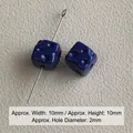 Macro view of 10mm dark blue acrylic cube beads with 2mm straight aperture for jewelry - Sapphire Blue