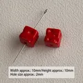 Macro view of small red acrylic cheese-shaped cube beads for DIY jewelry making - Red