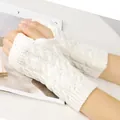 Close-up detail of white cable-knit fingerless gloves with thumb hole for autumn and winter warmth - One Size / White