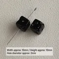 Macro detail of 10mm black acrylic cheese cube beads for DIY jewelry accessories - Black