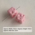 Close-up view of small pink acrylic cheese cube beads for DIY jewelry making accessories - Pink