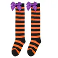 Close-up detail of children's orange and black striped Halloween socks with purple satin bows. - Kids (7-12 Years) / Orange Black Striped/Purple Bow