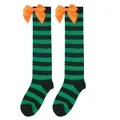 Close-up detail of Halloween over-knee socks with green stripes and orange satin bows - Kids (7-12 Years) / Green Black Striped/Orange Bow