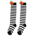 Detailed macro view of Halloween striped knee-high socks with plush pumpkin doll decor. - Kids (7-12 Years) / Pumpkin Doll Style / Black & White Thin Stripes