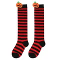 Macro view of Halloween themed striped knee-high socks featuring cute 3D pumpkin dolls - Kids (7-12 Years) / Pumpkin Doll Style / Red Black Thin Striped