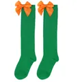 Close-up detail of children's green knee-high socks featuring vibrant orange satin bows. - Kids (7-12 Years) / Solid Green/Orange Bow