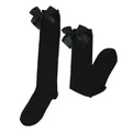 Detailed view of black knee-high socks with large satin bows for girls - Kids (7-12 Years) / Solid Black / Black Bow