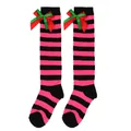 Close-up of pink and black striped knee-high socks with festive red and green bows - Kids (7-12 Years) / Double Layer Bow / Black Pink Stripes