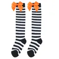 Detail of children's black and white striped knee-high socks with orange bows. - Kids (7-12 Years) / Black White Thin Striped/Orange Bow
