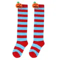 Macro view of red and blue striped children's Halloween socks with plush pumpkin dolls. - Kids (7-12 Years) / Pumpkin Doll Style / Blue Red Stripes