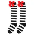 Detailed view of striped children's knee-high socks featuring vibrant red satin bows. - Kids (7-12 Years) / Wide Black and White Stripes with Red Bow