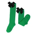 Detailed view of children girls green knee-high socks with elegant black satin bows decoration - Kids (7-12 Years) / Solid Green / Black Bow