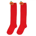 Detailed view of vibrant red Halloween knee-high socks featuring cute plush pumpkin dolls - Kids (7-12 Years) / Pumpkin Doll Style / Solid Red