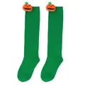 Detail showing plush pumpkin dolls attached to green Halloween knee-high socks for kids - Kids (7-12 Years) / Pumpkin Doll Style / Green