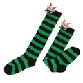 Close-up detail of festive green and black striped Christmas socks with cute reindeer doll - Kids (7-12 Years) / Green Black Stripes / Bow Reindeer