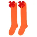 Close-up detail of vibrant orange girls' knee-high socks with festive red satin bows - Kids (7-12 Years) / Solid Orange with Red Bow