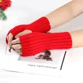 Macro detail of red knitted fingerless gloves showing ribbed texture and warm yarn - One Size / Red