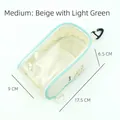 Detailansicht der mittelgroßen, beige-grünen, transparenten PVC-Puppentragetasche - M / Beige Und Grün