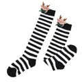 Close-up detail of children's black and white striped socks with cute reindeer plush doll - Kids (7-12 Years) / Thin Black White Stripes / Bow Reindeer