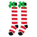 Close-up of red and white striped Christmas knee-high socks with large green bows - Kids (7-12 Years) / Red White and Black Stripes with Green Bow