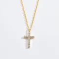 Close-up of elegant gold cross pendant necklace featuring sparkling Moissanite stones - Classic Cross / Yellow Gold Color