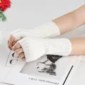Close-up of white knitted fingerless arm warmers showing ribbed texture and warm material - One Size / White