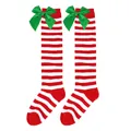 Festive red and white striped Christmas knee-high socks with large green satin bows for girls. - Kids (7-12 Years) / Thin Red and White Stripes with Green Bow