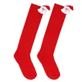 Pair of red children's Christmas knee-high socks with cute plush Santa Claus dolls on cuffs - 7-12 Years Old / Solid Red Santa Style