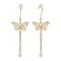 Detailed macro view of sparkling butterfly tassel drop earrings with moissanite crystals - Butterfly Tassel Style / Gold