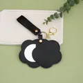 Minimalist black PU leather flower-shaped mirror keychain with elegant gold hardware - Black