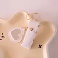 Mini white leather lipstick pouch keychain accessory with heart-shaped mirror charm - White