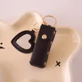 Black leather lipstick case and heart mirror keychain set with gold accents - Black