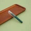 Mini portable pocket-sized green gel pen with a transparent cap displayed on a wooden tray - 0.5mm / Dark Green