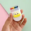 Portable 6-color rainbow face paint stick in a cute white case with a cartoon face design - Big Mouth