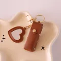 Brown pebbled leather lipstick holder featuring a mini heart-shaped mirror keychain - Brown