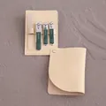 Portable manicure set with green nail clippers and a beige leather pouch - Dark Green Handle / Black