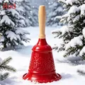 Detailed view of red European style metal handbell with floral patterns on snow - Totem Style / Red