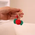 Handgebreide rood-groene gehaakte sleutelhanger in de vorm van snoep met gouden belletje - Snoepje (xmrysk) / Rood