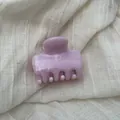 Detail shot of a light purple hair claw clip with a marble ink texture - S / Pink