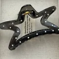 Close-up detail view of black star-shaped hair claw clip with white polka dot pattern - Five-pointed Star / Black White Polka Dot