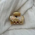 Detail view of a French style hair claw clip with brown marble ink pattern - S / Brown