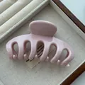 Detail of pink glossy dragon bone hair claw clip in a jewelry tray - PS Material / Pink