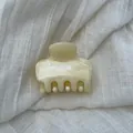 Macro detail of cream marble pattern on a French acetate hair claw clip for women's updos - S / Beige
