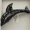 Detailed view of a sleek black dolphin-shaped hair claw clip with elegant white polka dots - Dolphin / Black White Polka Dot