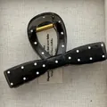 Close-up of semi-transparent black bow hair claw clip with white polka dots. - Bow Tie Shape / Black White Polka Dot