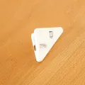 White plastic triangular corner clip for stationery organization and paper protection - White